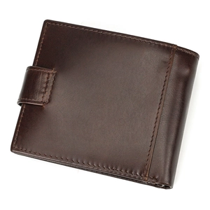 Macro shot of the deep brown genuine leather wallet with fine stitching and side buckle detail