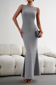 Detail of grey sleeveless knit dress featuring elegant textured pleats and fishtail hem