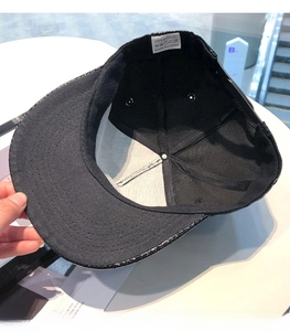Close-up of internal lining and 100% acrylic material wash label of this black snapback hat