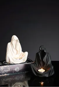 Detail of Nordic ghost wizard candle holders with matte resin texture and hood design