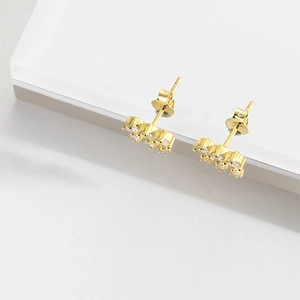 Elegant gold S925 silver stud earrings with white diamond flower design on white background