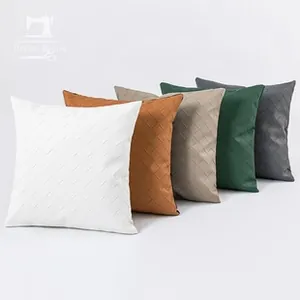 Detail showing high-quality faux leather woven checkered texture on square pillow covers