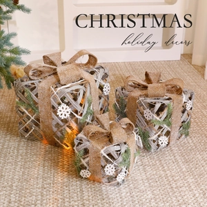 Three-piece beige rattan Christmas gift box set with burlap bows and warm LED lights