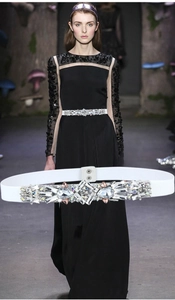 Macro detail of elastic white belt featuring luxury crystal and rhinestone buckle design