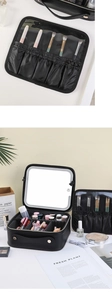 Black leather makeup bag with built-in LED mirror and adjustable internal dividers