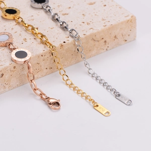 Gold, silver, and rose gold stainless steel bracelets with Roman numeral charms on stone