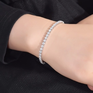 Detailed view of silver tennis bracelet with cubic zirconia inlay on a model wrist