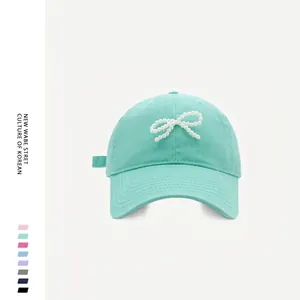 Mint green baseball cap with a decorative white pearl bow for women