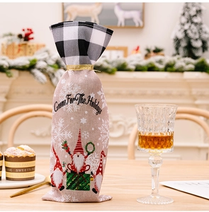 Macro detail of gnome Christmas wine bottle cover with plaid drawstring and burlap texture
