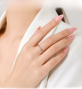 Detail eines eleganten gedrehten S925 Sterlingsilberrings am Finger des Models