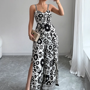 Elegant black and white floral wide-leg jumpsuit with slit legs and knotted straps