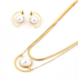 Detail of gold double-layer necklace and matching stud earrings with white pearls