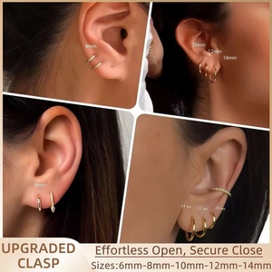 Close-up of golden hoop earrings featuring upgraded secure clasp and various sizing options