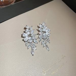 Macro shot of silver zircon leaf tassel earrings showing crystal facet details