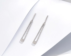 Detailed macro view of S925 silver drop earrings with micro-pave geometric U-shape fringe