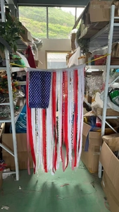 Detail of USA flag tassel banner with lace ribbons and pompoms for Independence Day décor