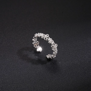 Detail of silver hollow flower ring with pavé zircons and adjustable open band