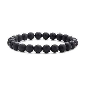 Detail view of 8mm matte black lava stone bead bracelet on a clean white background