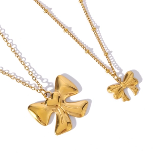 Elegant 18k gold plated stainless steel bow pendant necklace set on a clean white background