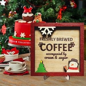 Macro shot of wooden Christmas coffee sign featuring snowflake, tree, and snowman decor