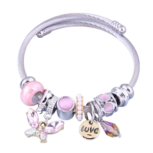 Close-up of DIY stainless steel bracelet with pink enamel beads and butterfly charms