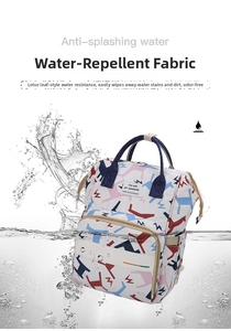 Close-up of waterproof printed diaper bag with splash effect showing liquid resistance