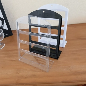 Three multi-tier acrylic earring stands in black, white, and clear for jewelry display