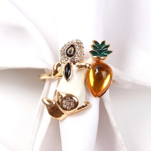 Detailed close-up of a gold metal bunny napkin ring with white enamel and rhinestones