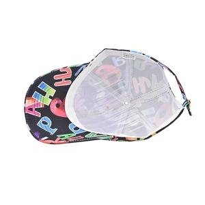 Detail view of cotton cap with graffiti print showing internal mesh and wash care label