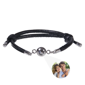 Detail of black woven leather projection bracelet with silver focal bead and photo stone