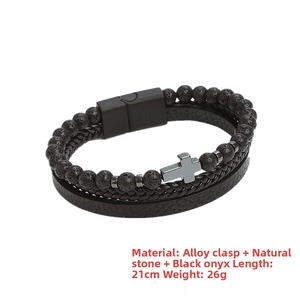 Detail showing the layered lava stone beads, braided leather and cross charm on a 21cm bracelet