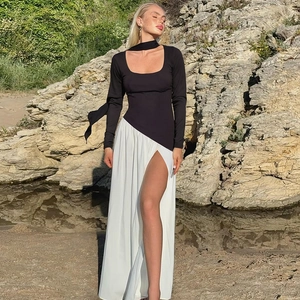 Détail de la robe contrastée noir et blanc avec fente haute et tour de cou au soleil