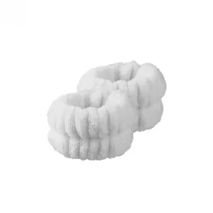 Macro view of white microfiber wrist washbands with soft absorbent coral fleece texture
