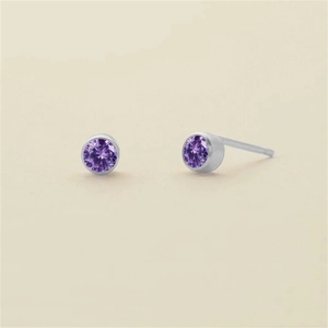 Minimalist gold-plated stainless steel stud earrings featuring deep purple round-cut crystals