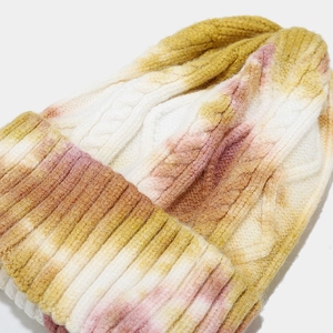 Detailed close-up showing tie-dye knit texture and twist pattern of the warm winter hat