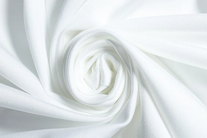 Macro shot of the white knitted fabric texture and soft fiber details of the dress