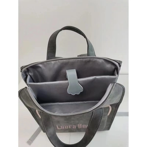 Detail of multi-functional dark grey backpack with padded laptop compartment and strap