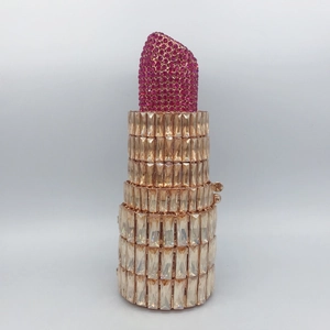 Detailed view of lipstick-shaped evening clutch with pink rhinestones and crystals