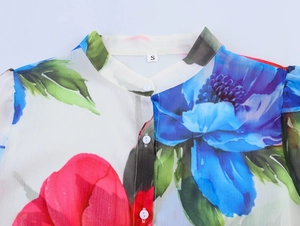 Detailed view of floral chiffon blouse neckline with size tag and delicate white buttons