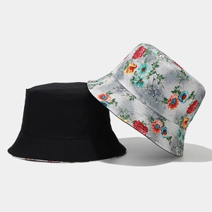 Detail of reversible sun hat showing floral print patterns and plain black cotton fabric