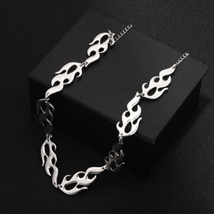 Silver punk flame necklace on black display box with industrial metallic texture