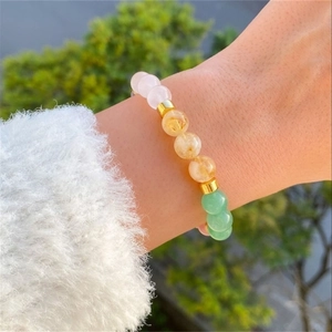 Handcrafted natural gemstone bracelet with colorful amethyst and quartz beads on a wrist