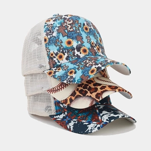 Three western style trucker hats featuring floral, leopard, and tribal print with mesh back