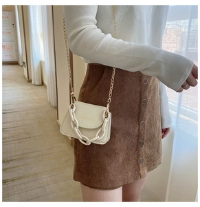 Mini off-white jelly crossbody bag with acrylic chain and brand logo on white outfit
