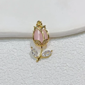 Gold tulip pendant with pink oval stone and zircon accents on a white background