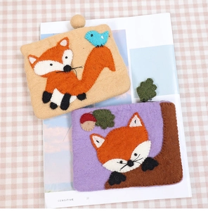 Detailed view of handmade wool felt coin purses with cute fox and forest animal embroidery