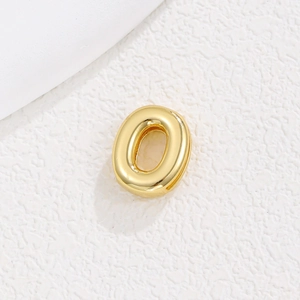 Macro shot of gold-plated 10mm metal letter charm for DIY mesh bracelets