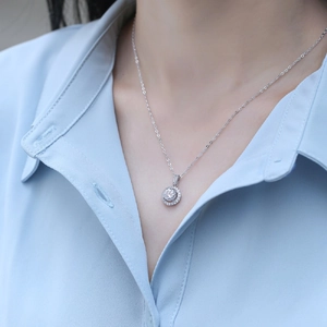 Elegant S925 silver Moissanite halo necklace on a model with a classic round pendant