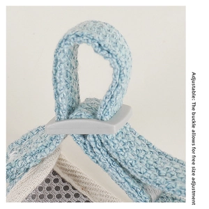 Detail of adjustable strap showing the grey plastic slider and breathable white mesh fabric