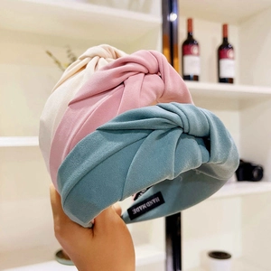 Detail showing high-quality handmade knotted headbands in beige, pink, and grey blue colors